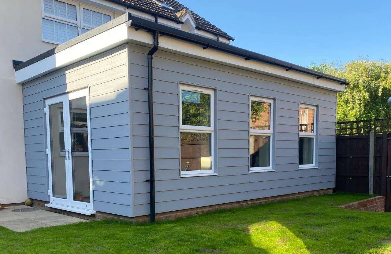 Clad single-storey garden building with French doors
