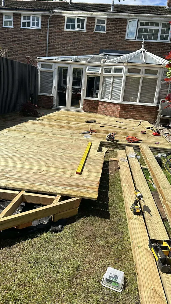 Deck frame under construction in a back garden