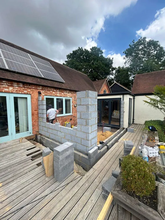 Decking and block-built raised beds at the back of a house