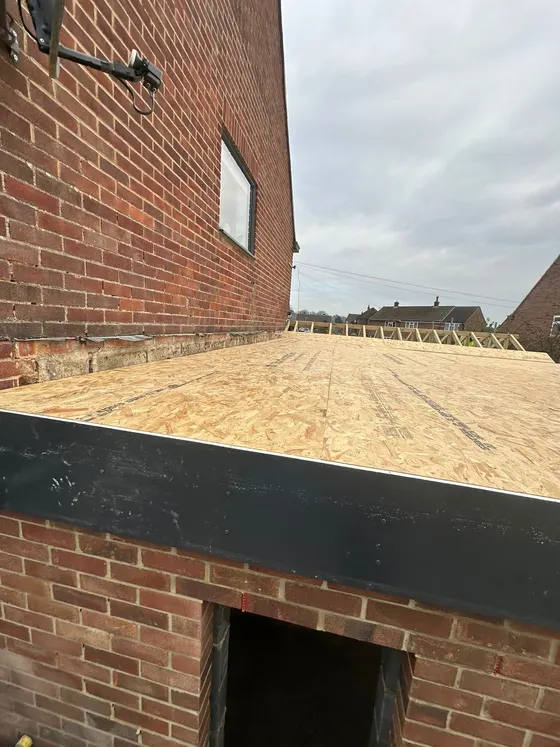 Flat roof deck edge on a brick extension