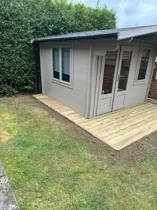 Grey garden room with double doors on a new timber deck