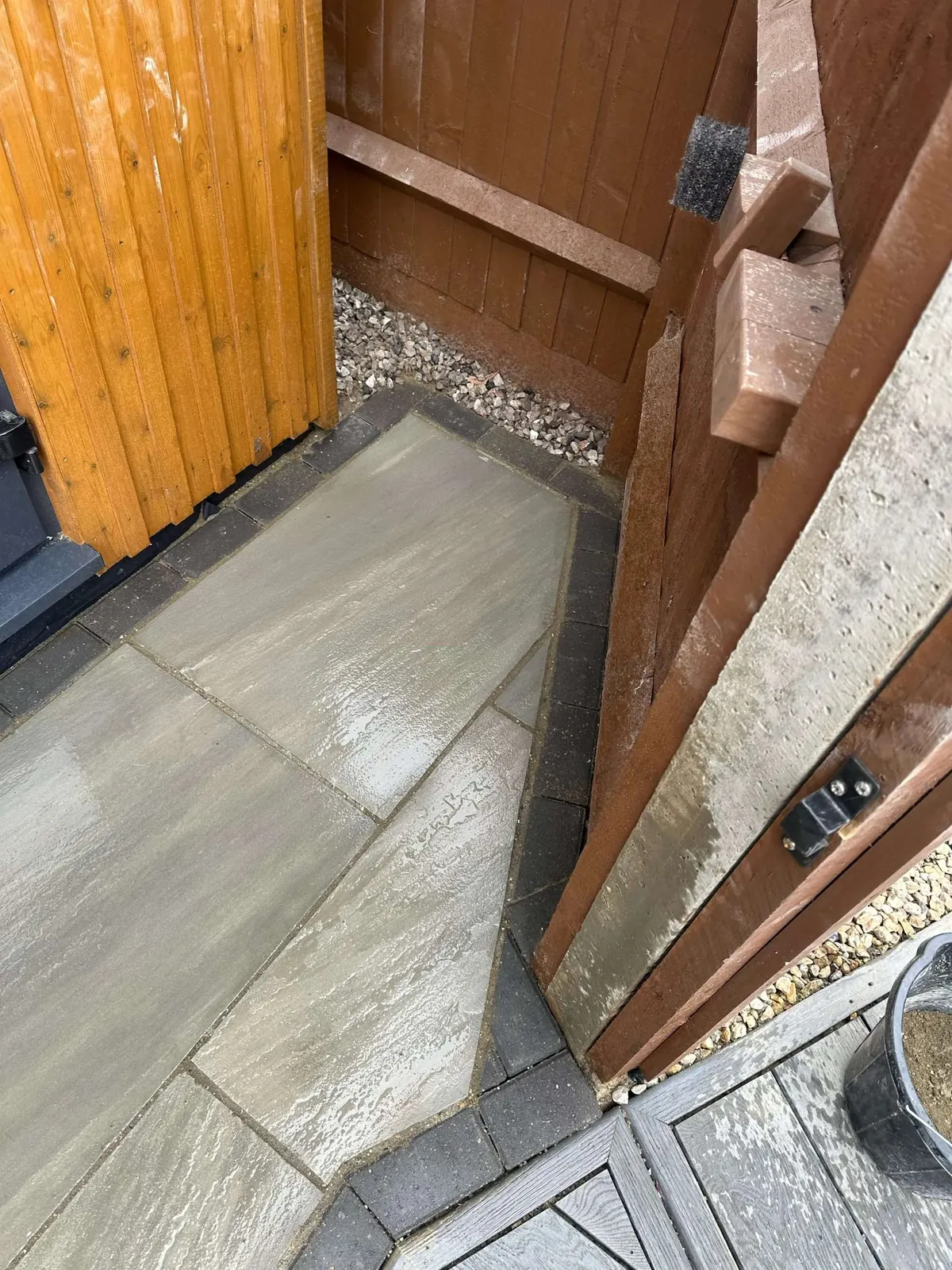 New timber gate and post beside fresh porcelain paving