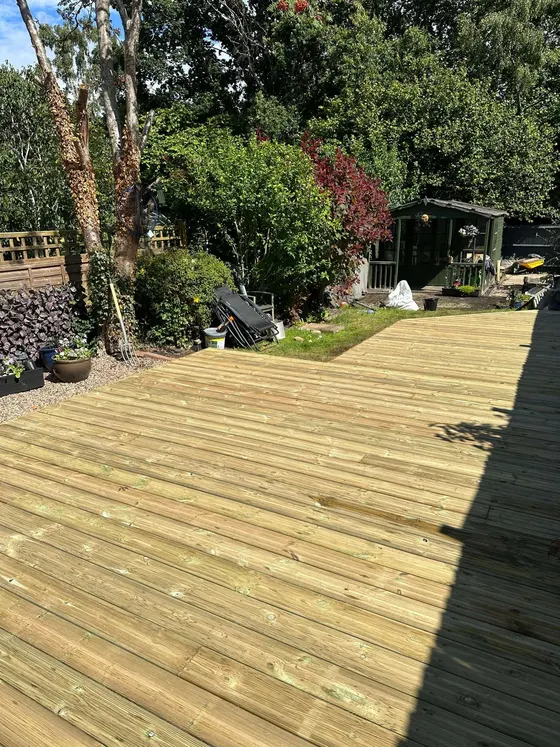 Newly laid decking boards in a leafy garden