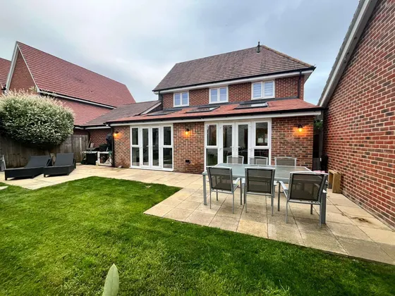 Finished patio and lawn behind a new-build house