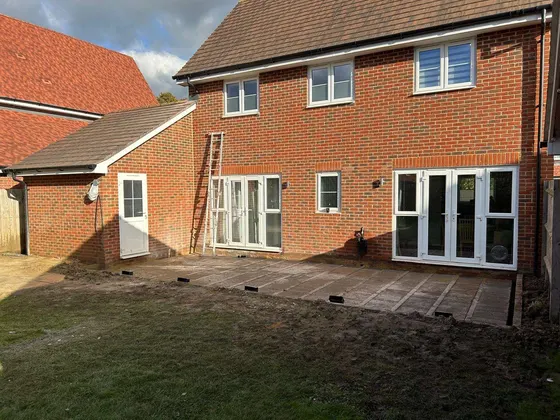 New patio laid behind a house, ready for turf