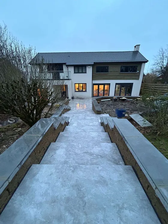 Long porcelain steps running down a garden to the house
