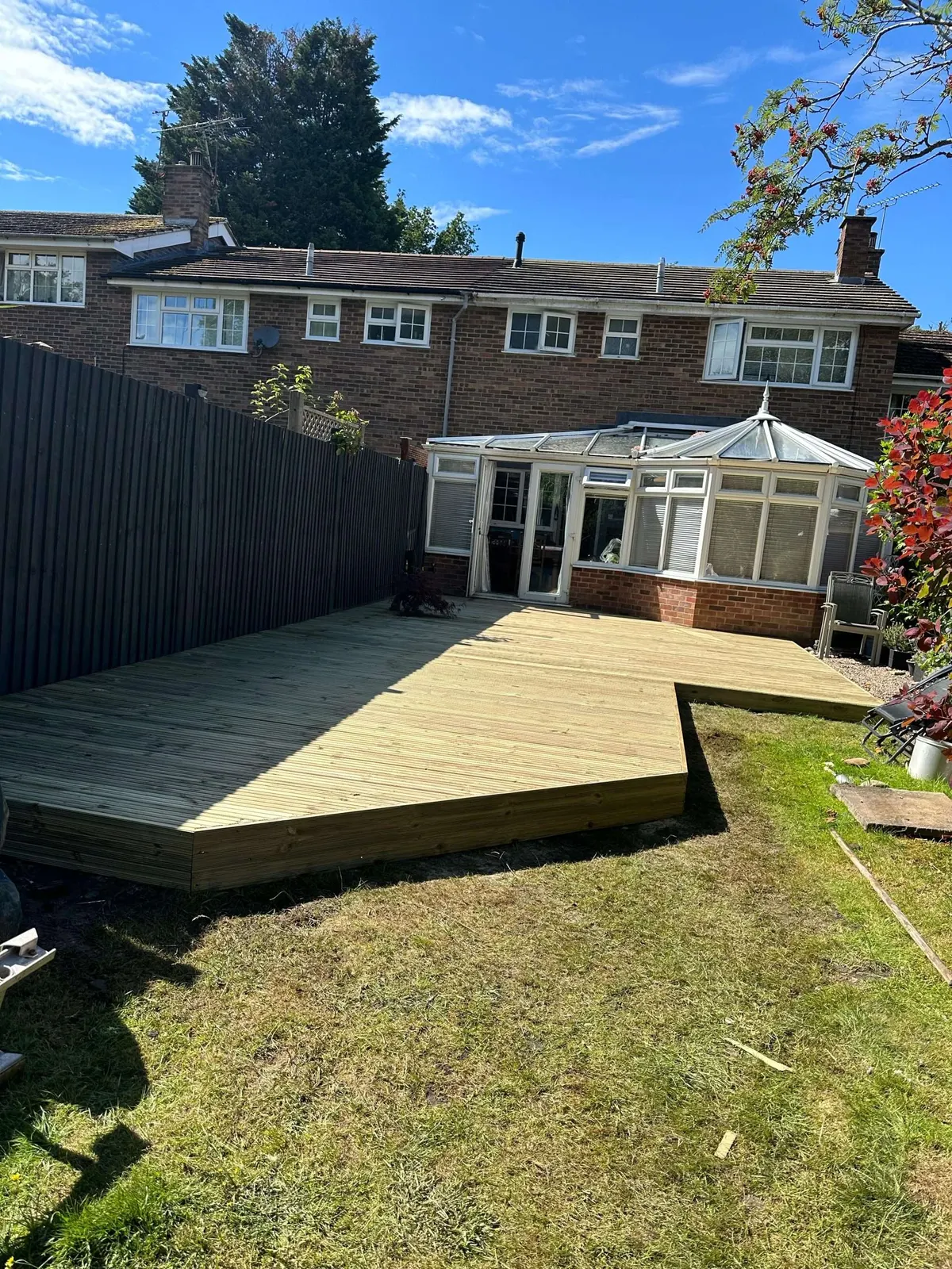 Raised timber deck outside a conservatory