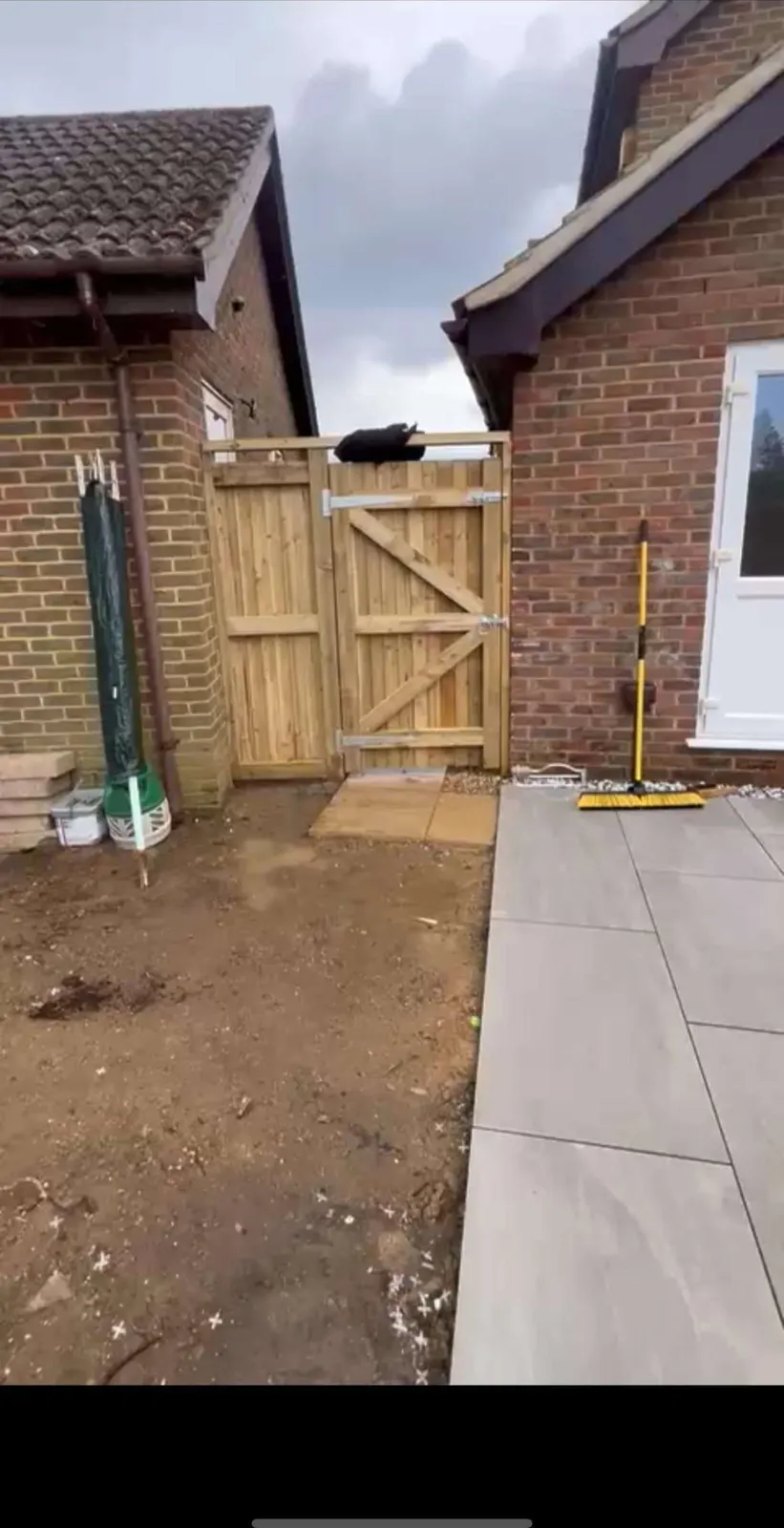 New timber side gate at the end of a porcelain path