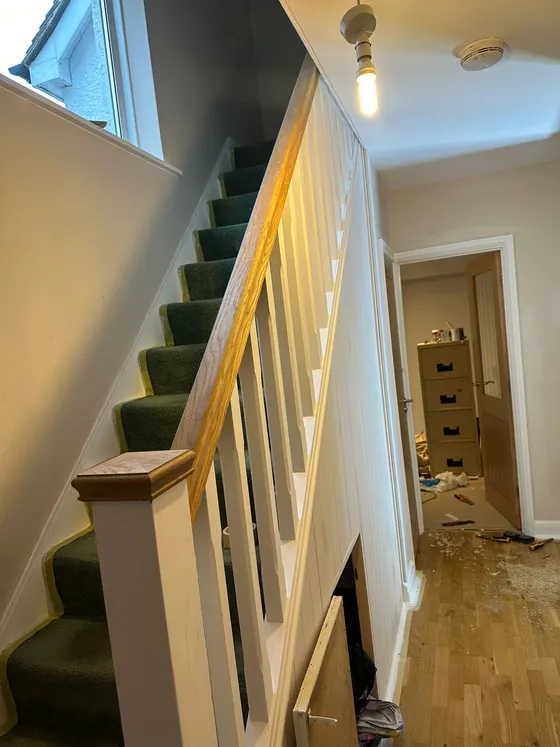 Staircase with a new oak handrail and newel post