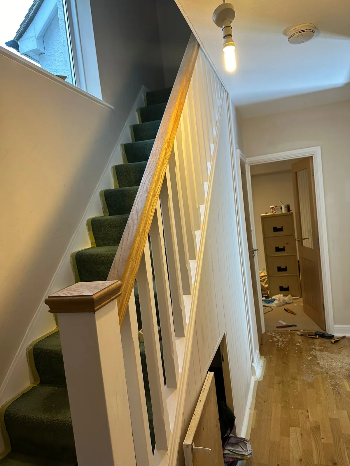 Staircase with a new oak handrail and newel post