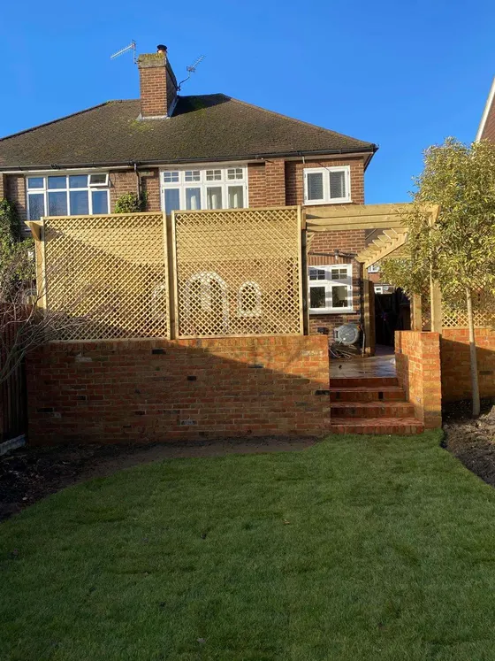 Trellis screening panels on a garden wall above a new lawn
